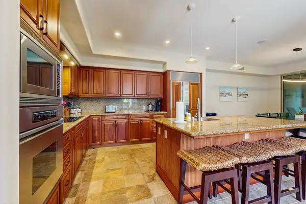 Upgraded kitchen with all of the amenities and stainless steel appliances.  Large island for extra counter space and with four barstools.
