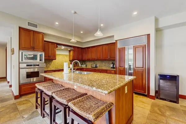 Upgraded kitchen with all of the amenities and stainless steel appliances.  Large island for extra counter space and with four barstools.