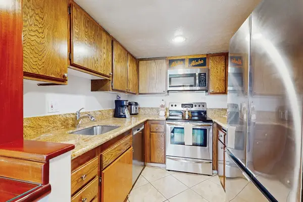 Prepare your favorite meals in the fully equipped kitchen featuring stainless steel appliances.