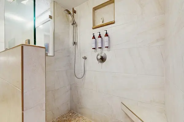 Refresh in the full bathroom featuring a walk-in shower and modern finishes.