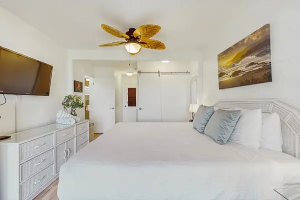 The spacious primary bedroom offers a peaceful retreat with plenty of natural light.