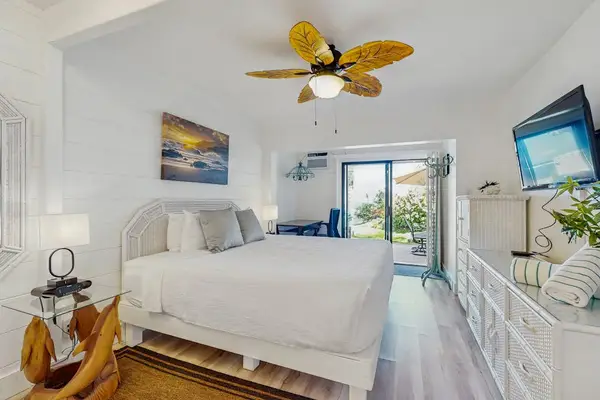 Recharge in the inviting guest bedroom with direct access to the tropical patio.