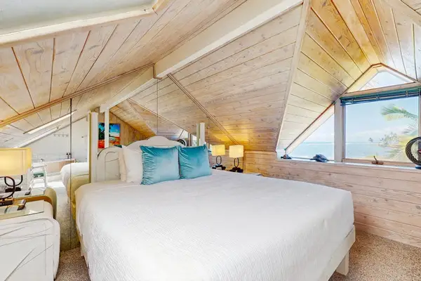 Retreat to the cozy loft bedroom with a comfortable king bed and warm wood interiors.