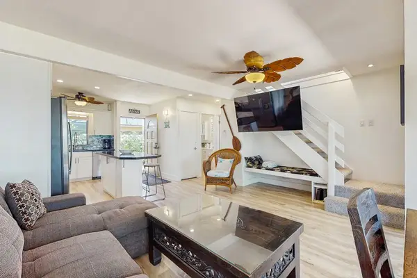 Unwind in the spacious living room with comfortable seating and modern island style.