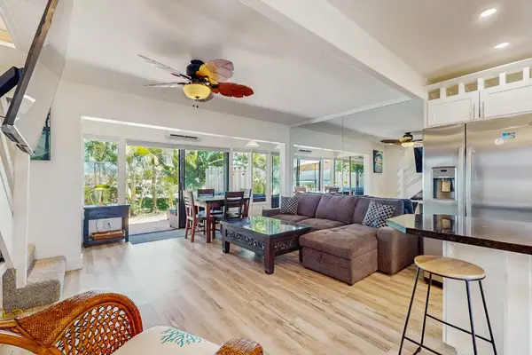 The bright open-concept living room is perfect for relaxing and gathering together.