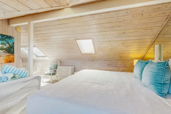 Wake up in the inviting loft bedroom filled with natural light and island charm.
