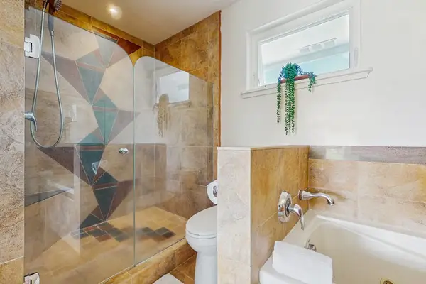 Compact modern bathroom layout featuring a walk-in glass shower