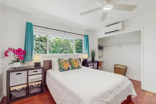 Compact bedroom designed with a breezy, tropical aesthetic