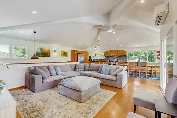 This open-concept great room features a bright, airy coastal style designed for group gatherings