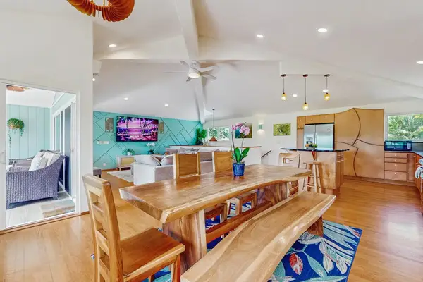 The great room seamlessly combines a dining area, kitchen, and living space