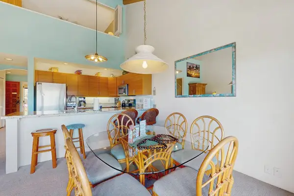 Open dining kitchen area combines seating counters and abundant sunlight