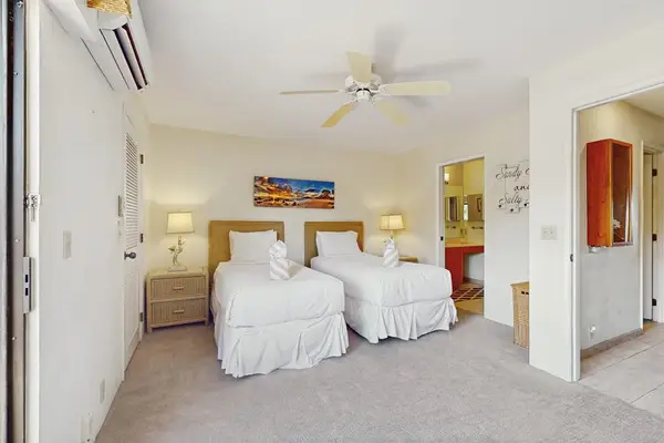 Welcomes island breezes with twin bedding and windows