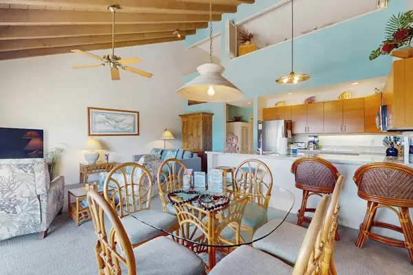 Dining area showcases chairs beside kitchen counters and garden light