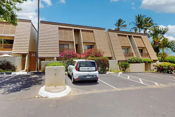 Exterior building entrance offers convenient parking beside landscaped resort grounds