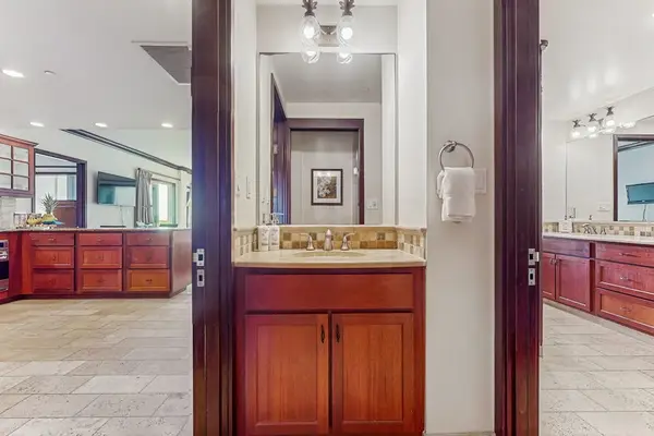 Luxurious secondary en suite featuring dual sinks, a large soaking garden tub, and a spacious tiled walk-in shower.