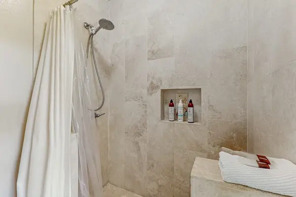 Walk-in Travertine Tiled Shower with Bench & Handheld Showerhead