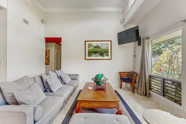 Sun-Drenched Living Space with Modern Seating & Tropical Garden Views