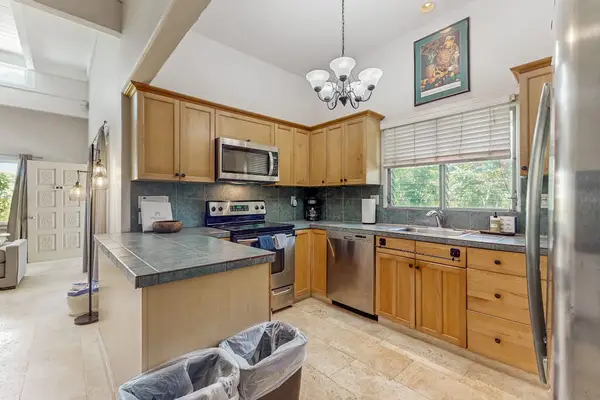 Fully Equipped Kitchen featuring Tile Countertops & Modern Appliances