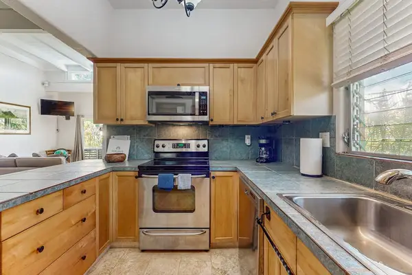 Bright Kitchen View showing Stainless Steel Range, Microwave & Sink