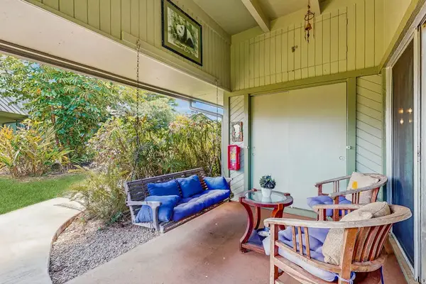 Covered Private Patio Featuring Porch Swing & Garden Seating