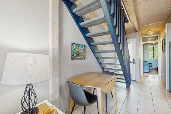 Dining nook beneath staircase provides a cozy setting for meals