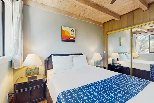 Spacious bedroom soft linens, natural light, and useful furnishings