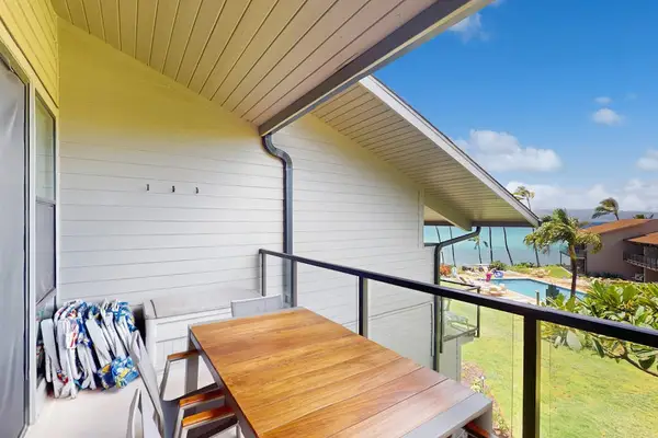 Covered balcony provides outdoor dining with ocean and garden views