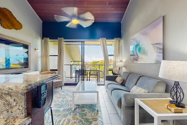 Bright lounge showcases white furnishings, ocean scenery, and coastal artwork