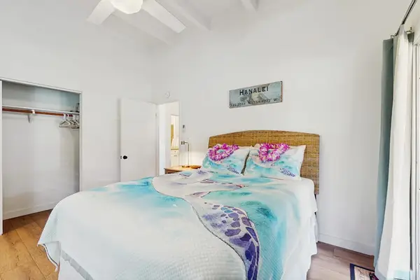Inviting sleeping area pairs plush bedding with thoughtful touches and restful ambiance