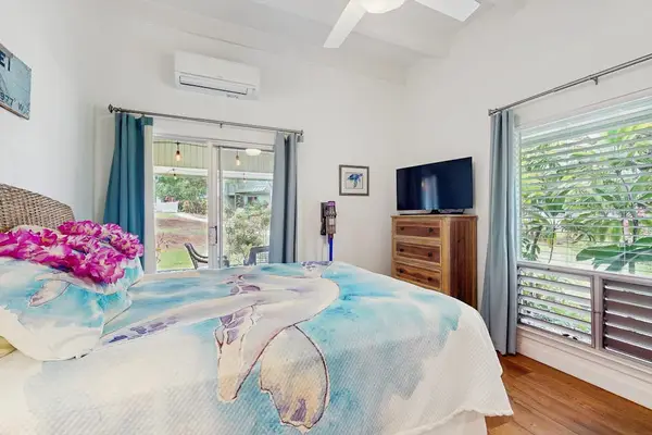 Serene bedroom showcases layered bedding, soft lighting, and curated furnishings.
