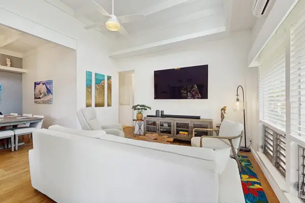 Spacious living room blends cozy seating with elegant details and cheerful daylight.