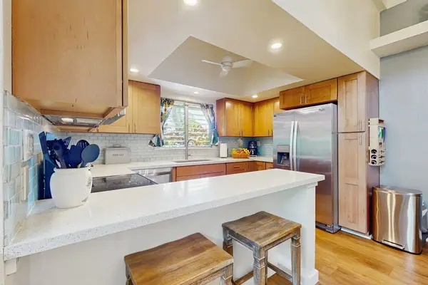 Well-equipped kitchen features modern appliances, ample counters, and convenient storage