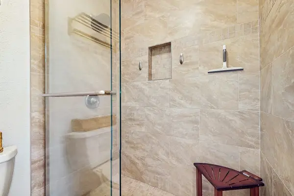 Updated bathroom offers  essentials, comforting vibes, and refreshing shower.