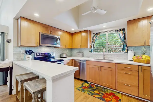 Functional kitchen includes spacious appliances and convenient meal preparation space.