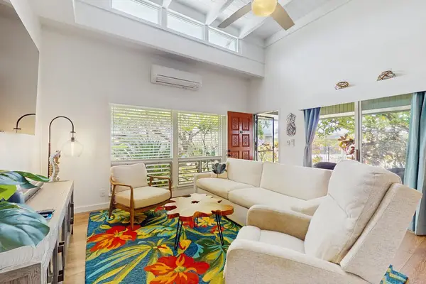 Living room seating frames bright windows and relaxed island gathering