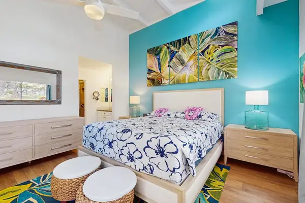 Comfortable bedroom offers restful bedding, tasteful decor, and peaceful natural light