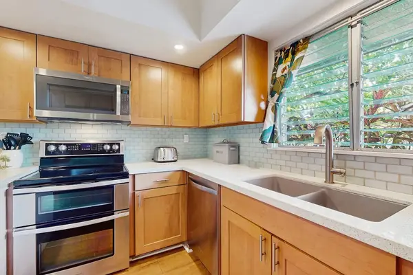 Contemporary kitchen showcases sleek cabinetry, cooking essentials, and organized countertops