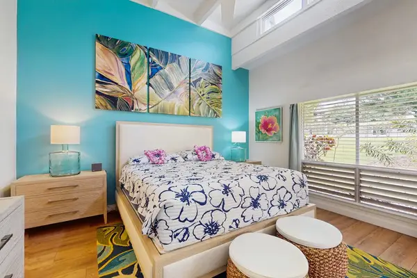 Peaceful sleeping space features comfortable bedding, tasteful furnishings, and soothing decorative touches