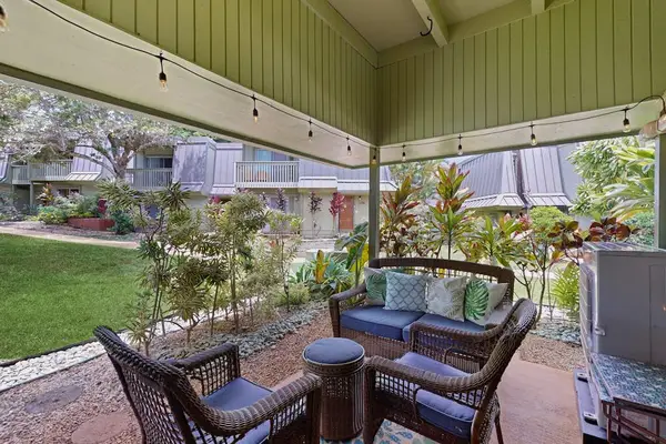 Covered patio dining offers shady meals beside colorful landscaped gardens