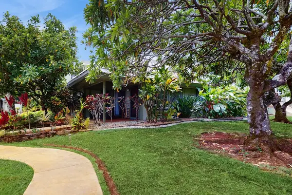 Home exterior blends design with landscaped grounds and convenient access