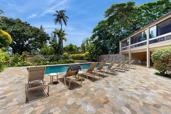 Inviting pool setting provides comfortable relaxation beside tropical garden surroundings