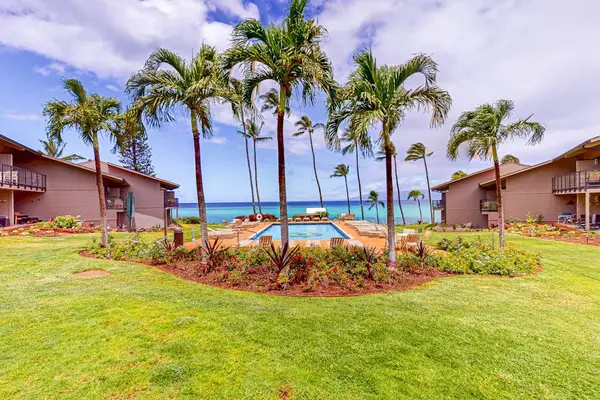 Resort-Style Courtyard With Pool And Palm Trees