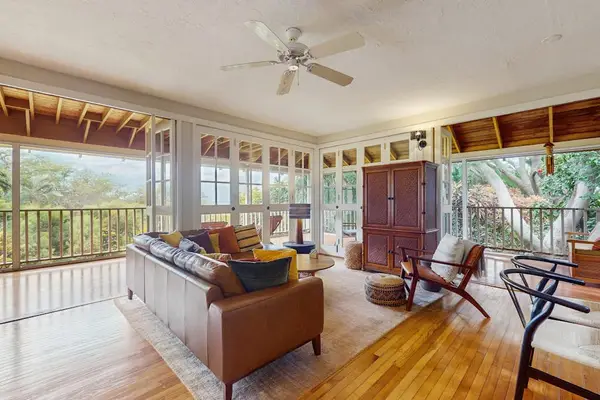 Lovely living room blends comfortable seating with sweeping views through expansive glass walls