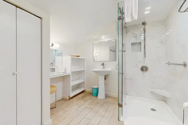Guest bathroom with walk-in tiled shower.