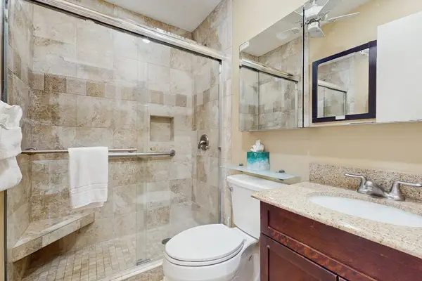 Master bathroom with large walk-in tiled shower.