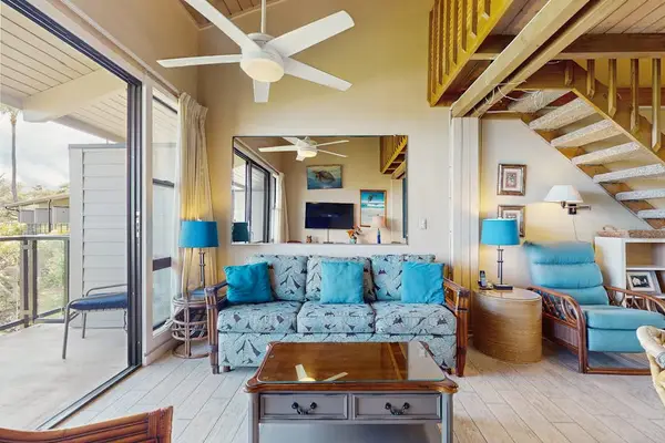 Living room open to the loft with access to the lanai.