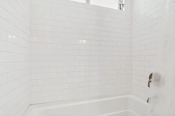 Tiled Shower and Bathtub Area with Bright White Subway Tile