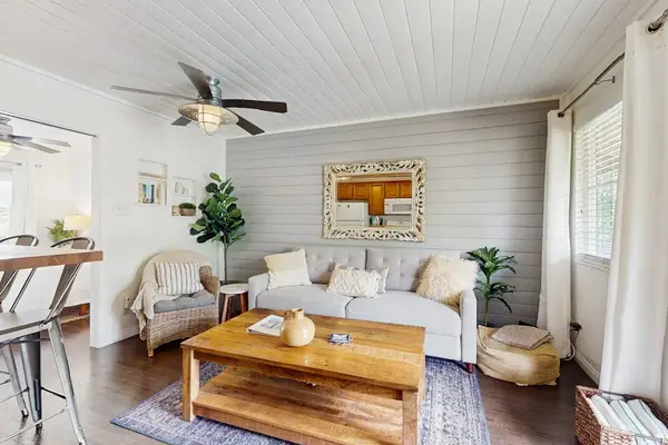 Bright Living Room featuring Neutral Sofa, Wood Coffee Table & Shiplap Wall