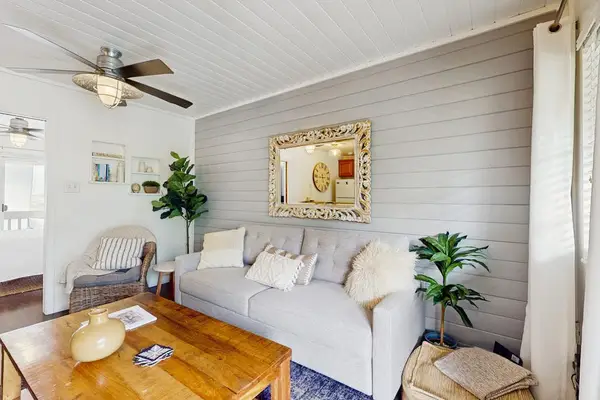 Alternate Living Area View Highlighting Plush Sofa & Coastal Decor