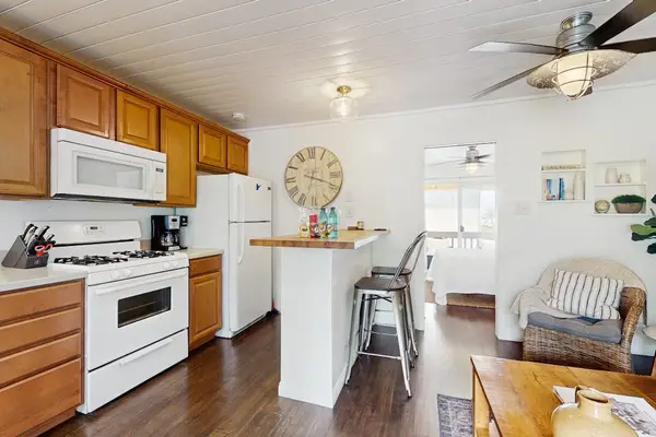 Fully Equipped Kitchen with Gas Range, White Appliances & Breakfast Bar
